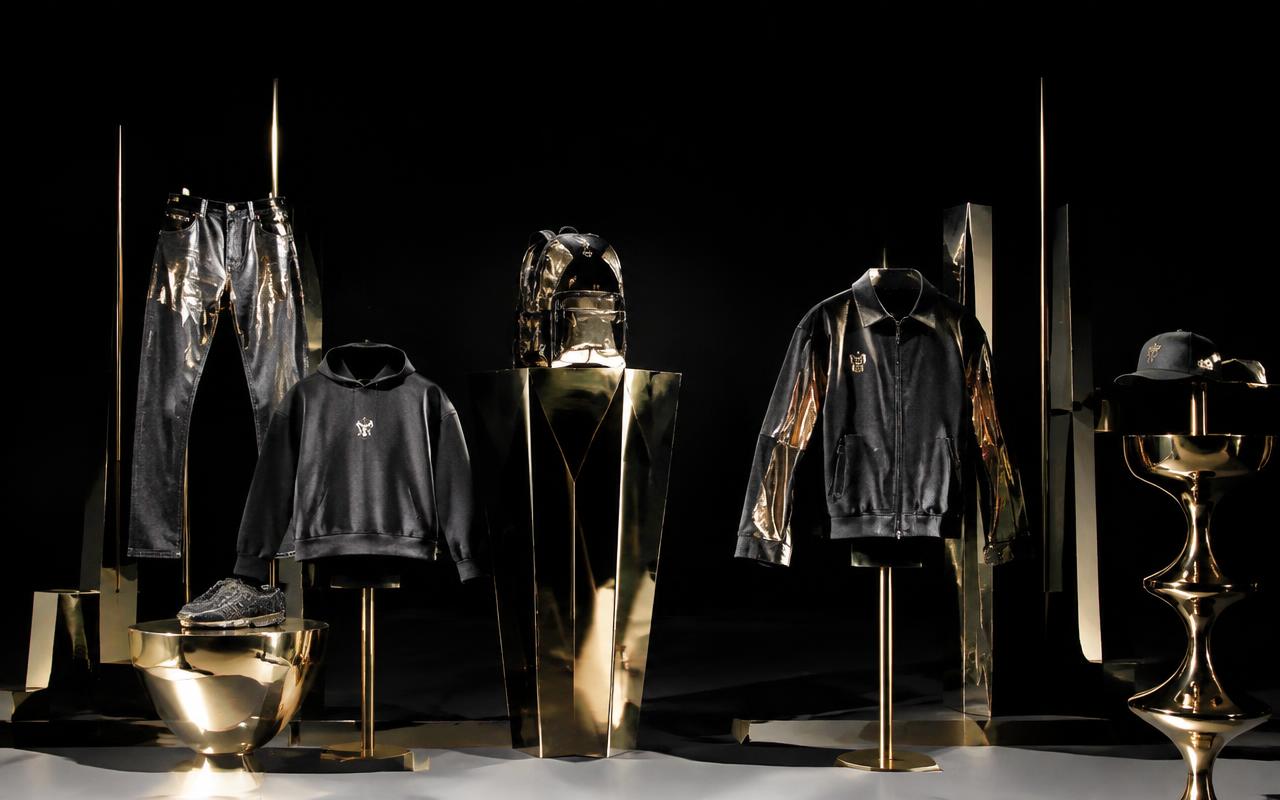 Chrome-detailed streetwear pieces on sculptural stands with metallic gold highlights